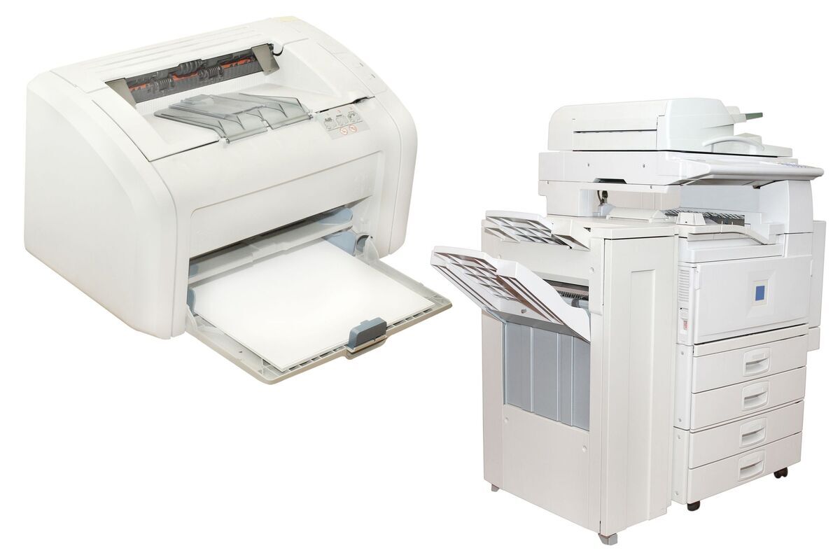 Two printers side by side; a compact home printer on the left and a larger, multifunction office printer with multiple trays on the right.